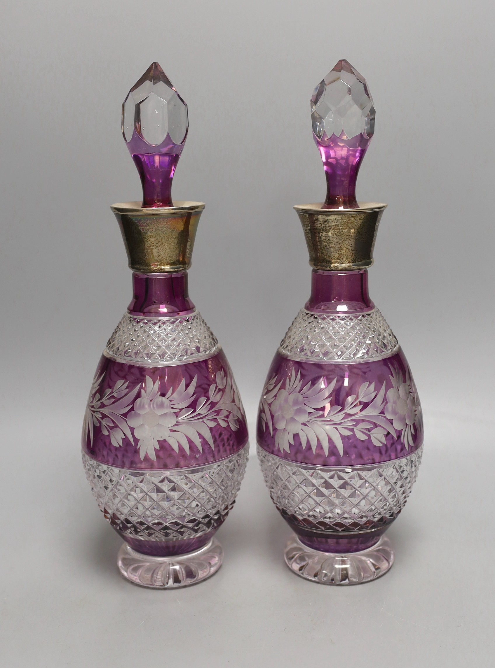 A pair of Bohemian silver mounted cut and amethyst flashed glass decanters and stoppers, 33cm